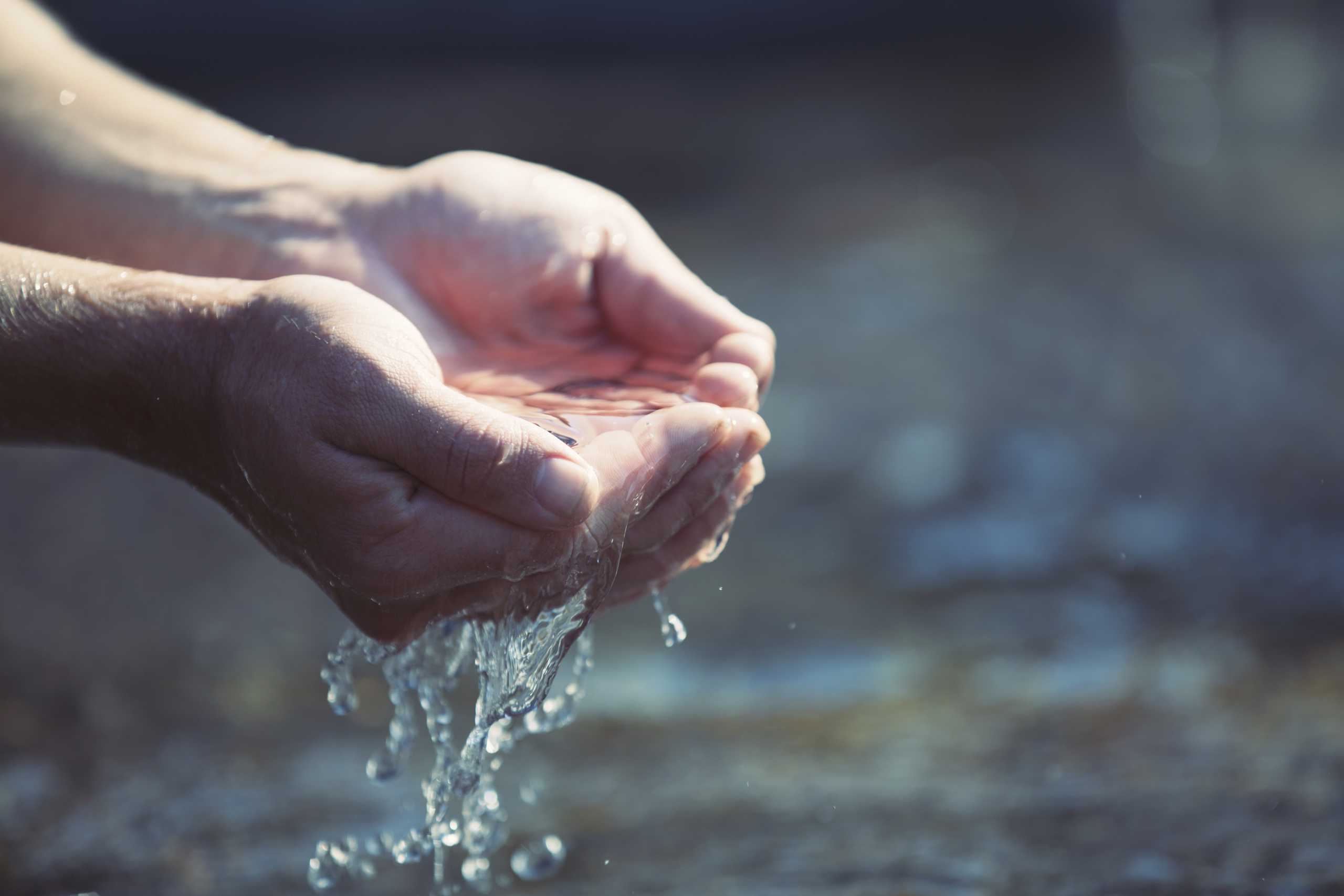 water running through cupped hands