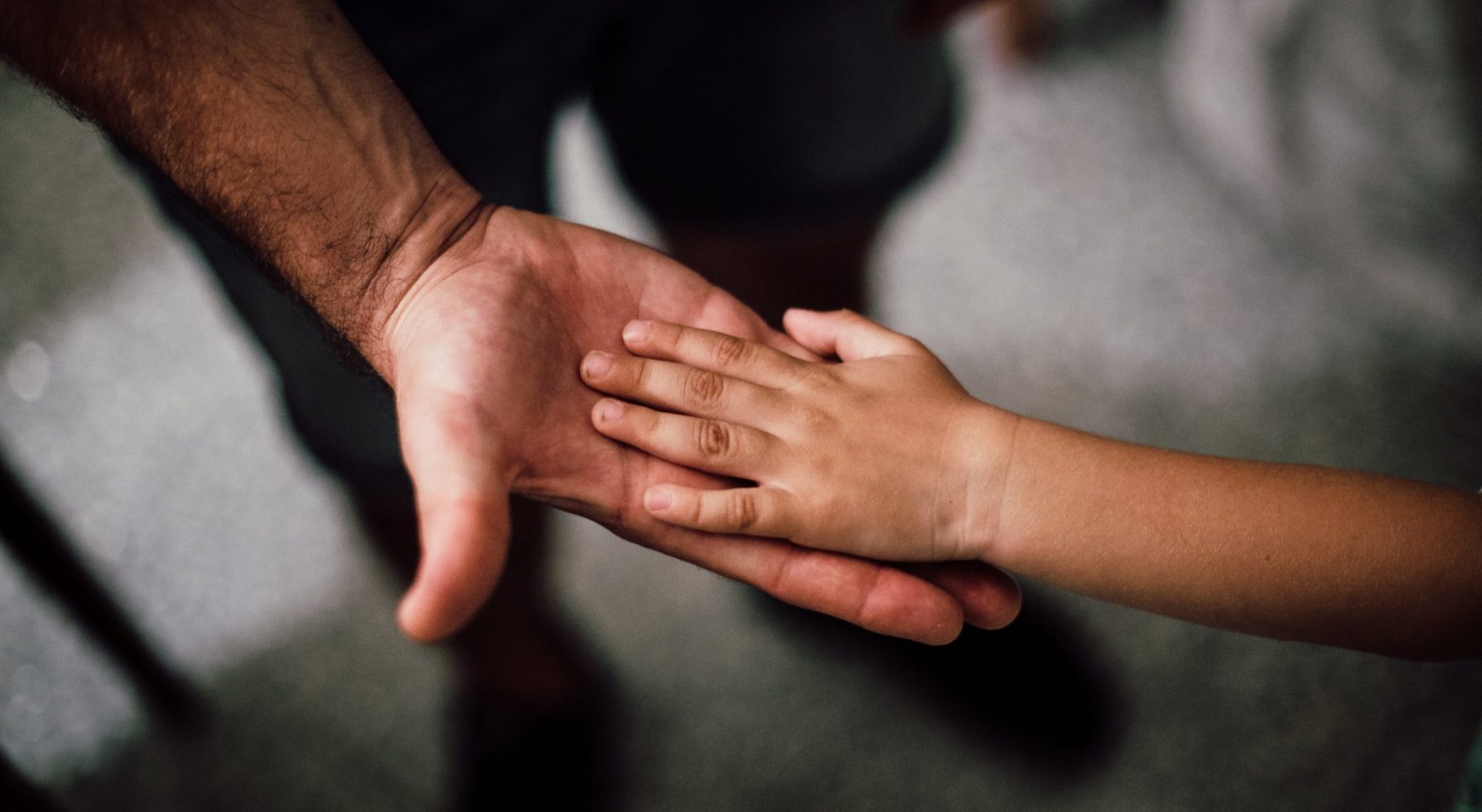 adult and child holding hands