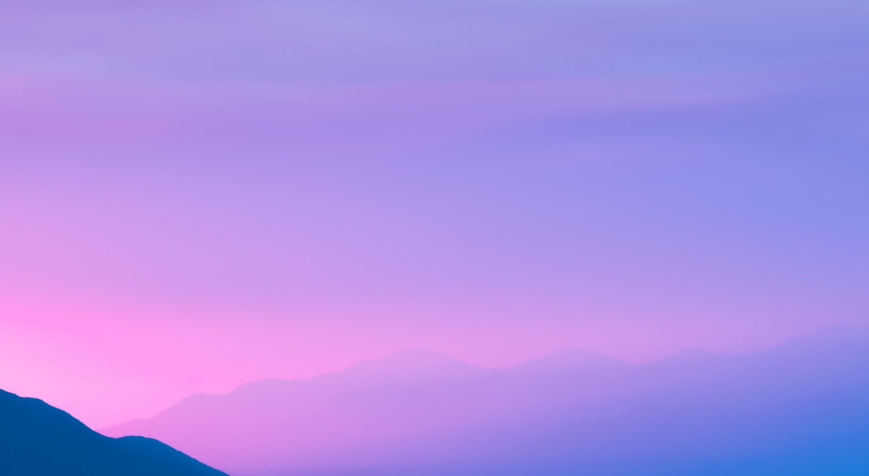 Brilliant purple pink sky over mountains