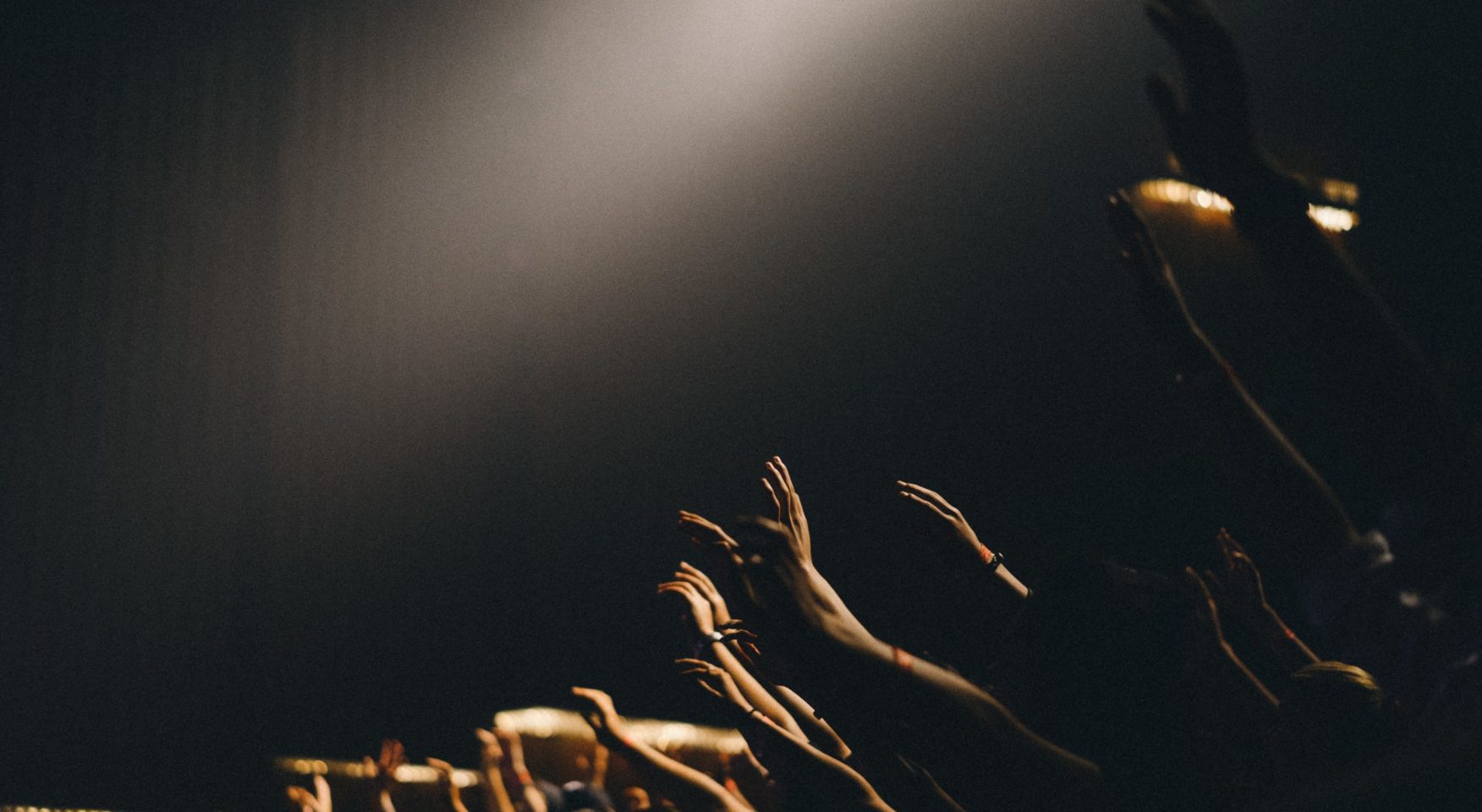 People worshipping in a dark room