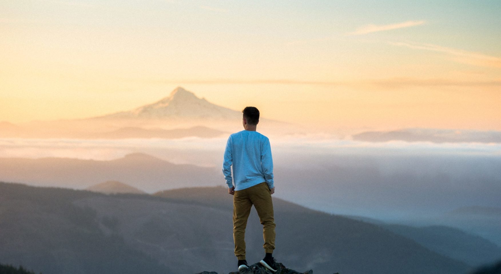 Dude gazing at mist on mountain tops