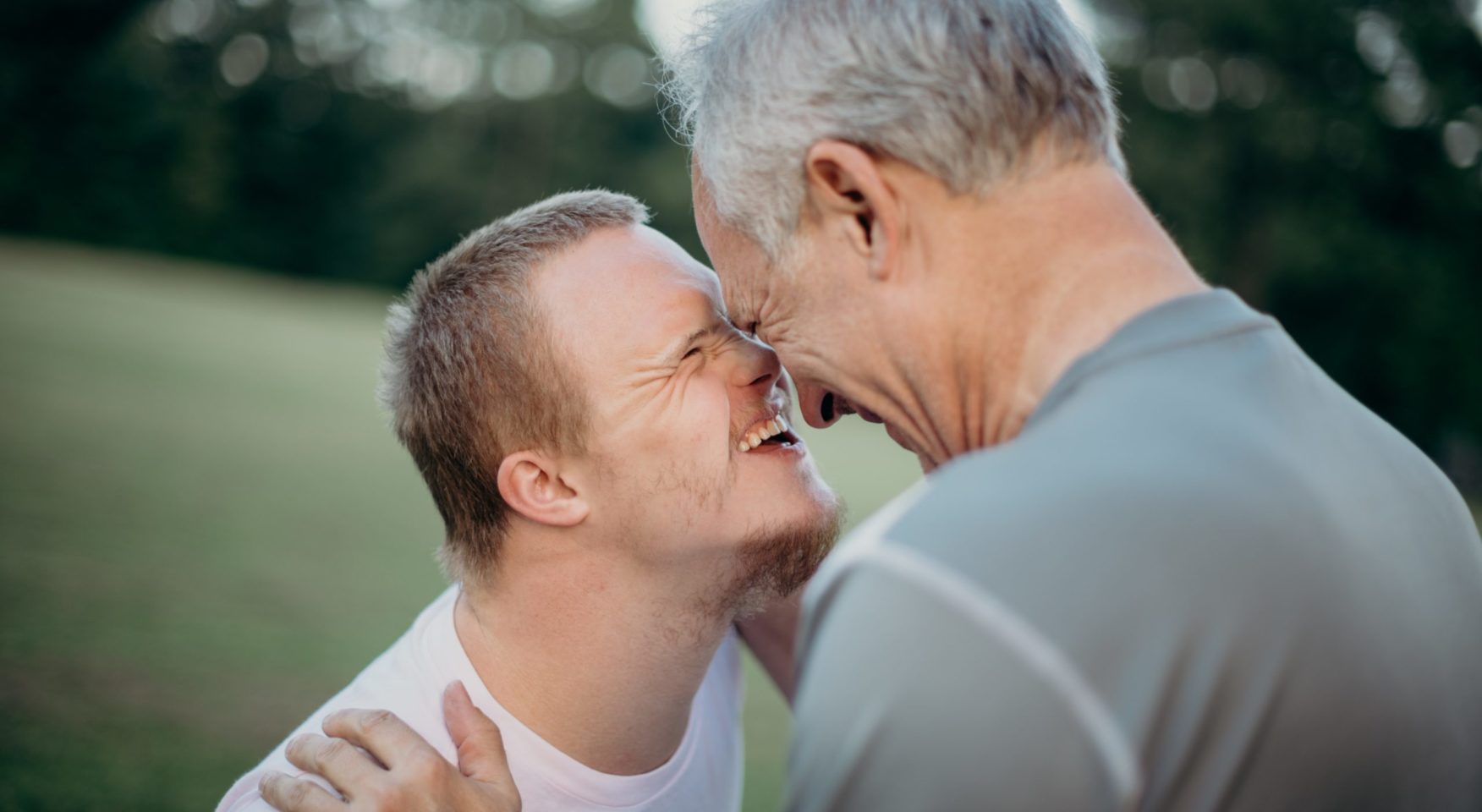 Father and son lovingly bumping noses and smiling