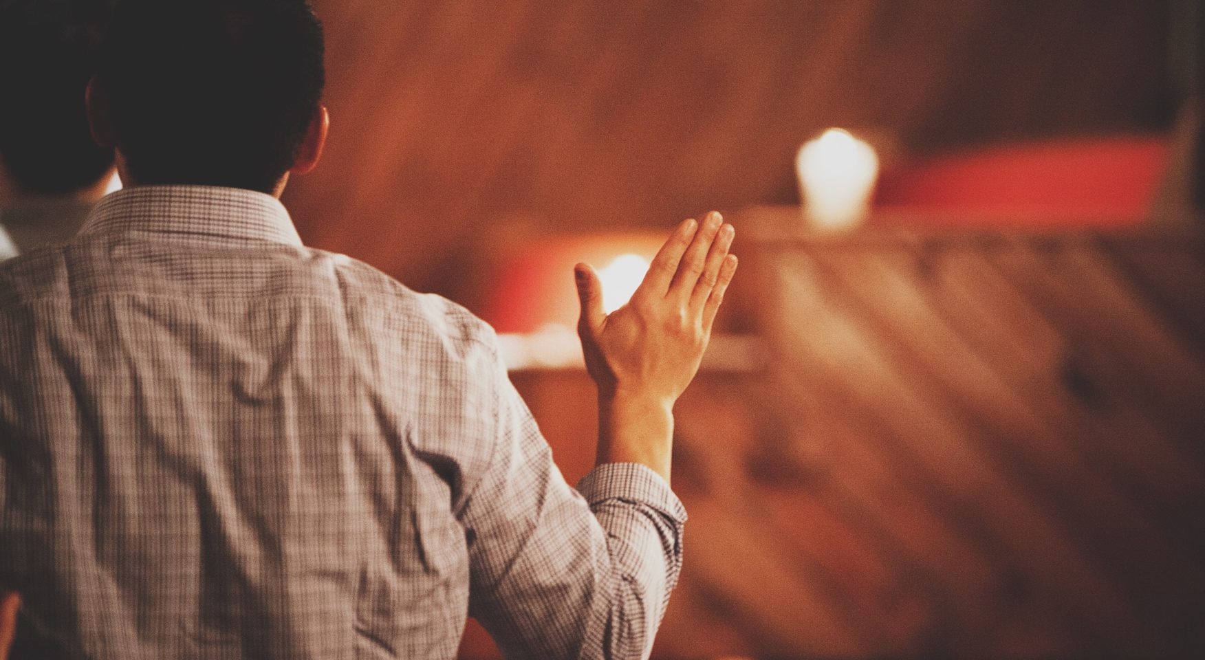 Man worshipping at wooden altar