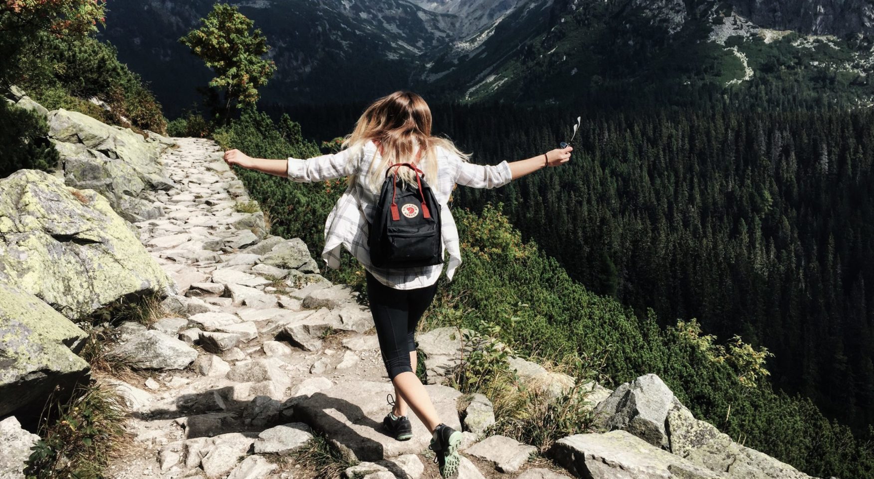 woman hiking on mountain rocks