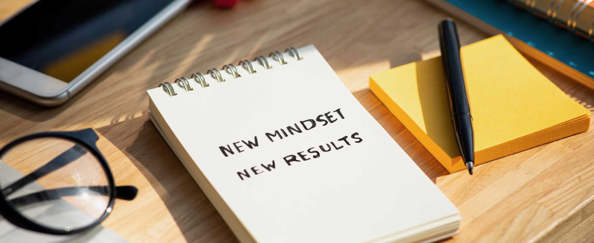 New mindset new results concepts with text on notepad on desk. positive thinking and motivation of business.